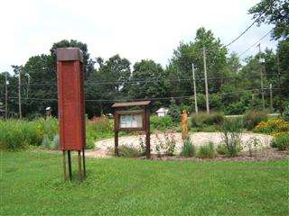 A swift tower stands to offer one pair of Chimney Swifts a nest site at the Linworth Alternative Program High School, Worthington City Schools. Designed for nesting swifts, the tower can only accommodate several hundred roosting birds during migration.